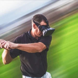 A man playing Golf Driving Range Challenge at an office event