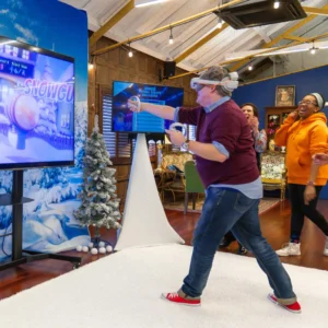 a man wearing virtual reality headset playing a video game