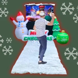 Man playing virtual reality golf ball game at a Christmas party