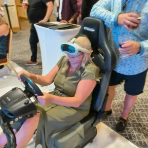 a woman wearing goggles and a steering wheel