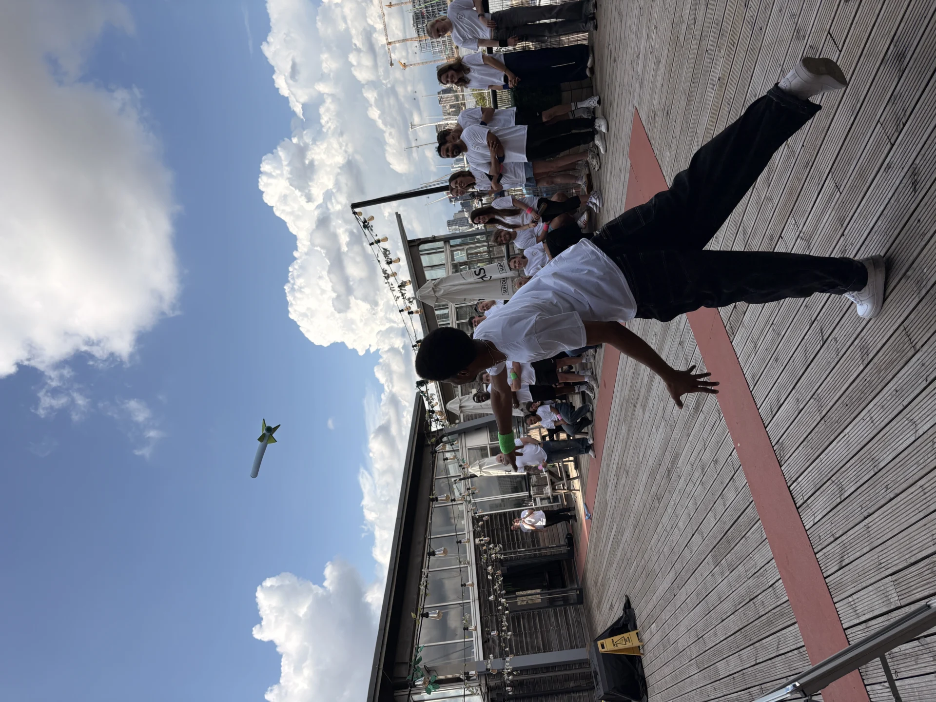 Team taking part in an outdoor paper plane challenge